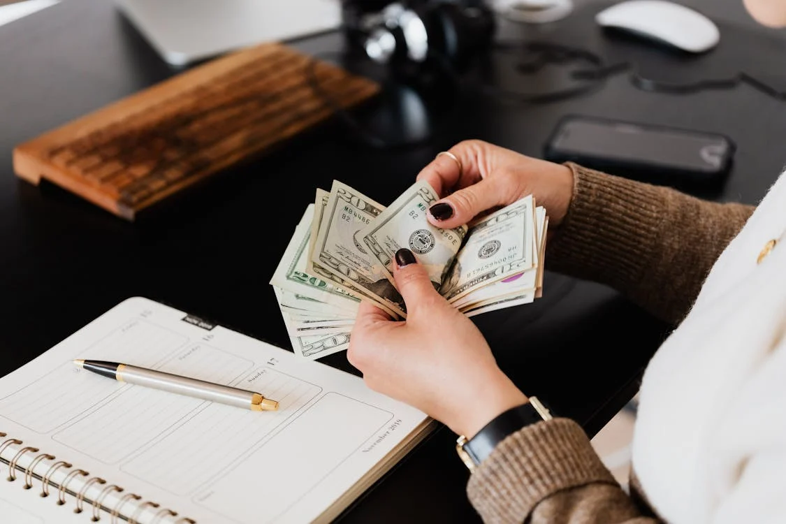 Accountant counting dollar bills.